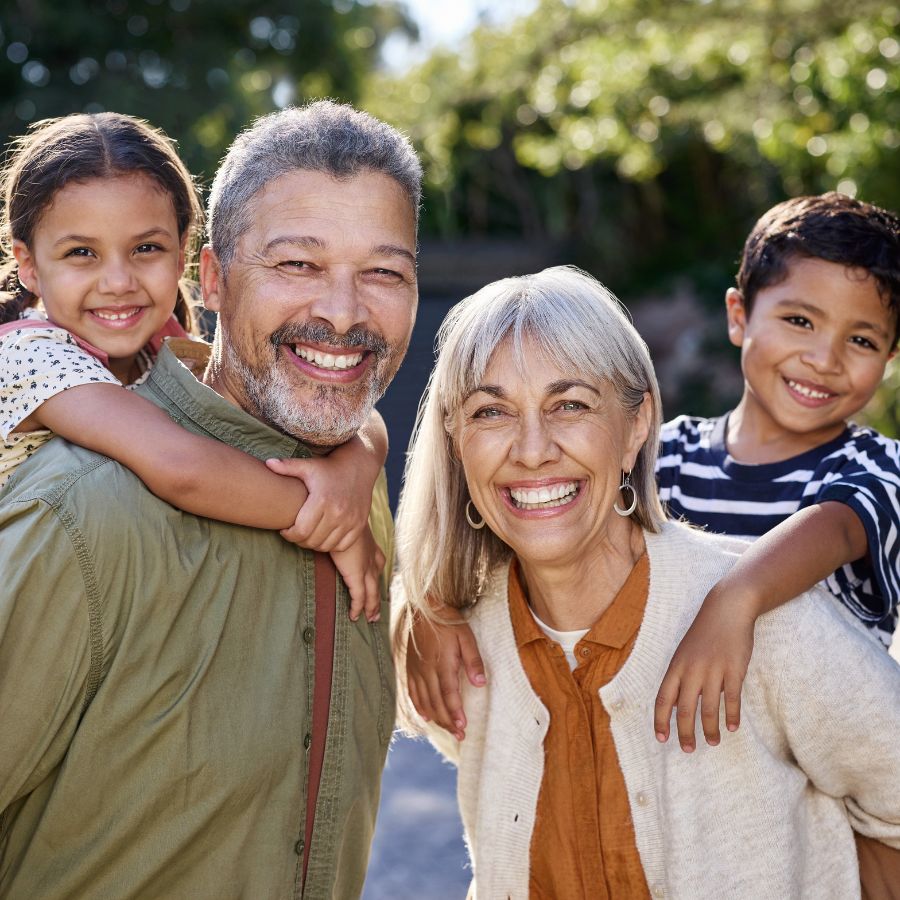 Portrait of happy multiethnic grandparents and smiling grandchild